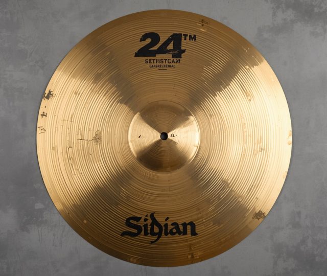 Brass cymbal on a concrete wall